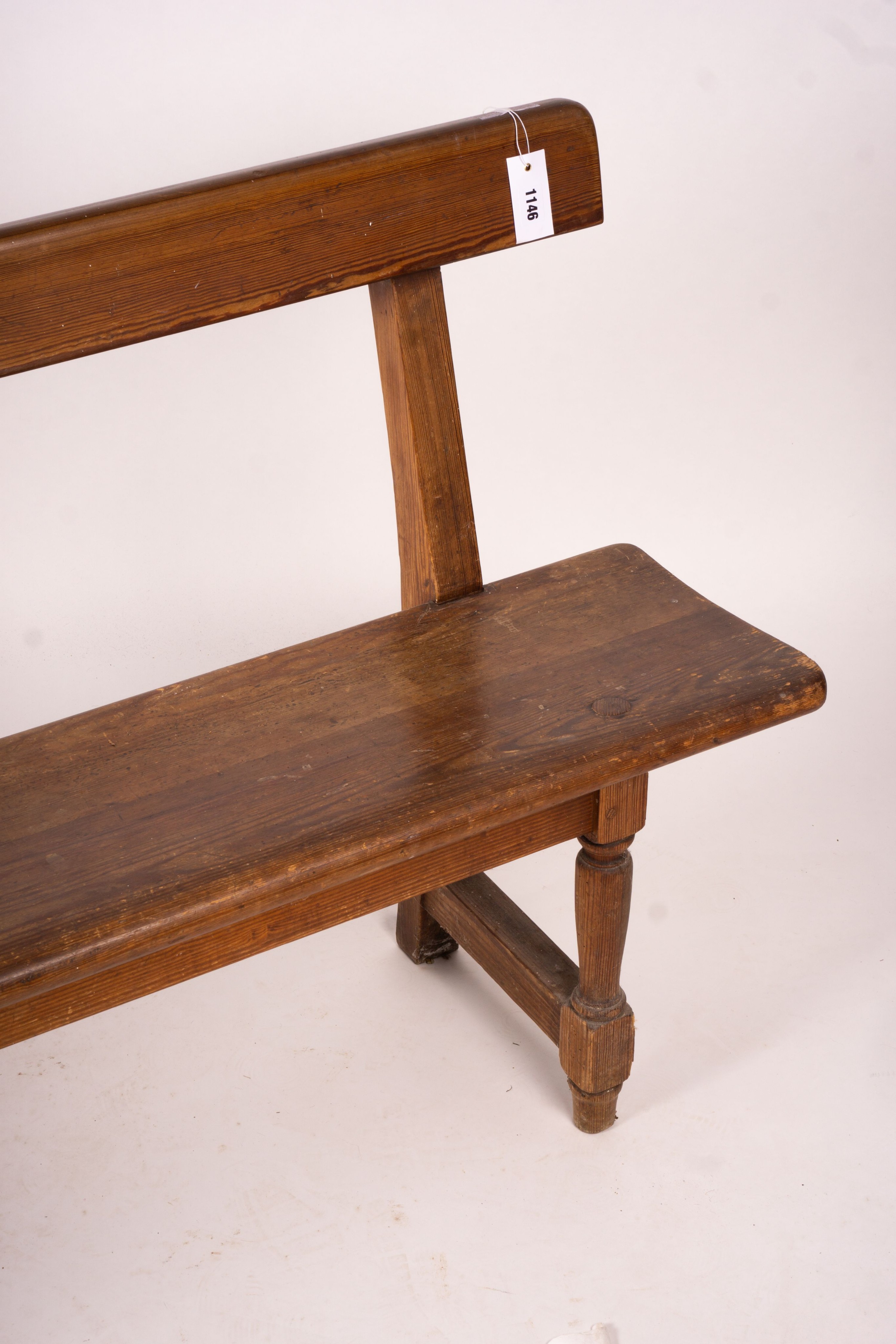 A Victorian pitch pine bench seat, W.214cm H.79cm